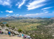 "Panoramic viewpoint over the Lasithi Plateau farmland with the sea visible in the distance"